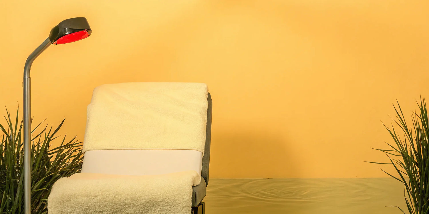 A red light therapy lamp set up over a chair for a wrinkle treatment.