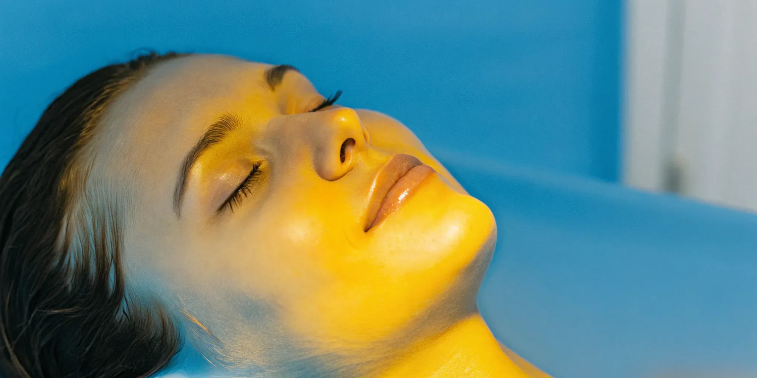 Woman getting blue LED light therapy on her face for clearer skin.