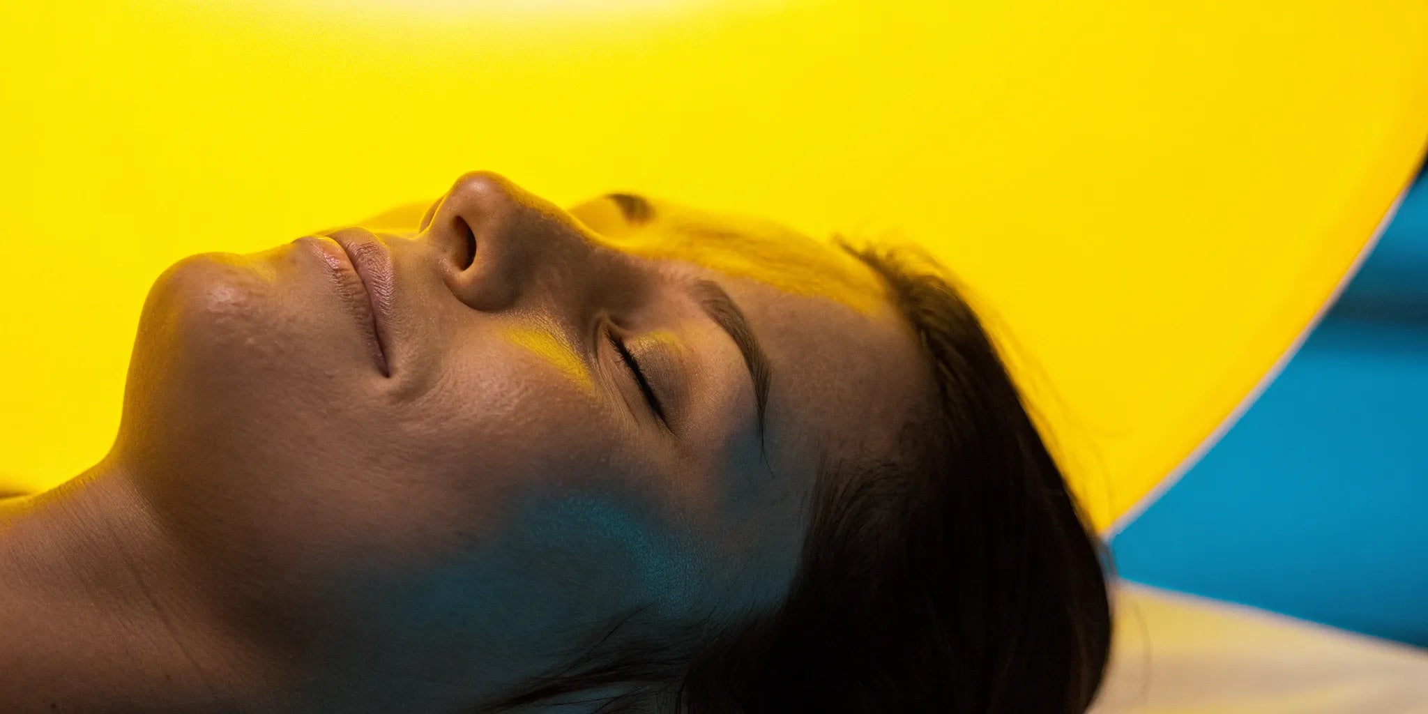 Yellow LED light therapy calming rosacea on a woman's face.